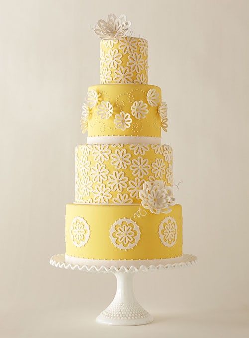 Sunshine yellow wedding cake decorated with lacy flowers. So cheery!: 